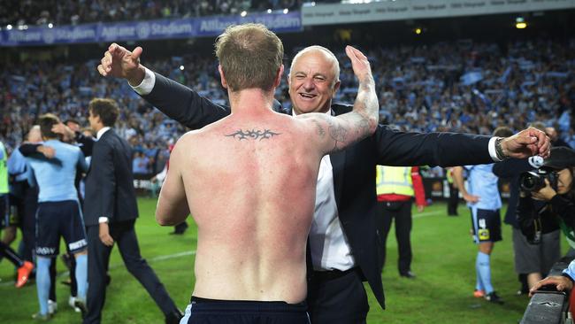 Sydney FC David Carney and coach Graham Arnold celebrate victory after winning penalty goal shootout defeating Melbourne Victory in the 2017 A-League Grand Final at Allianz Stadium, Sydney. Picture: Brett Costello