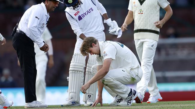 Australia's Cameron Green was hit in the head while attempting to field off his own bowling from a shot by India's Jasprit Bumrah during day one of the India v Australia A day/night tour match at the SCG. Picture: Phil Hillyard