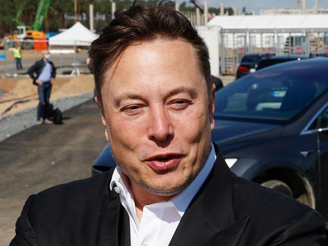 Tesla CEO Elon Musk talks to media as he arrives to visit the construction site of the future US electric car giant Tesla, on September 03, 2020 in Gruenheide near Berlin. - Tesla builds a compound at the site in Gruenheide in Brandenburg for its first European "Gigafactory" near Berlin. (Photo by Odd ANDERSEN / AFP)