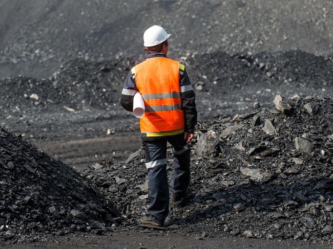 Coal mining in an open pit - Worker is looking on the huge open pit