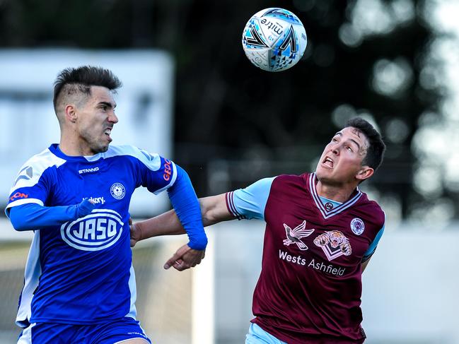 Alejandro Sanchez Lopez, left, and Joshua Symons tussle for the ball. Picture: Brendan Esposito