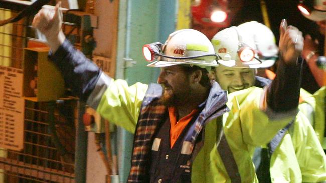 Tasmanian miners Todd Russell, left, and Brant Webb wave as they emerge from the mine lift having been rescued after being trapped underground at Beaconsfield gold mine for 14 days in 2006. Picture: IAM WALDIE/GETTY