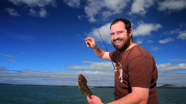 Dane Hansson (correct), 29 of West Moonah catching a couple of flathead to cook up for dinner tonight off McGee's Bridge at Midway Point.