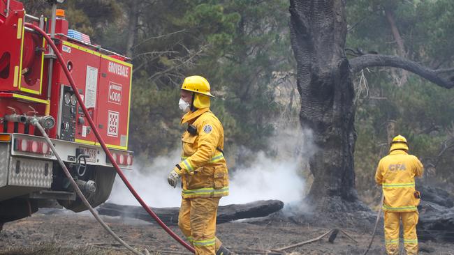 Fire fighters mop up hot spots in the bushfire area north of the Beaufort area on Friday. Picture: David Crosling