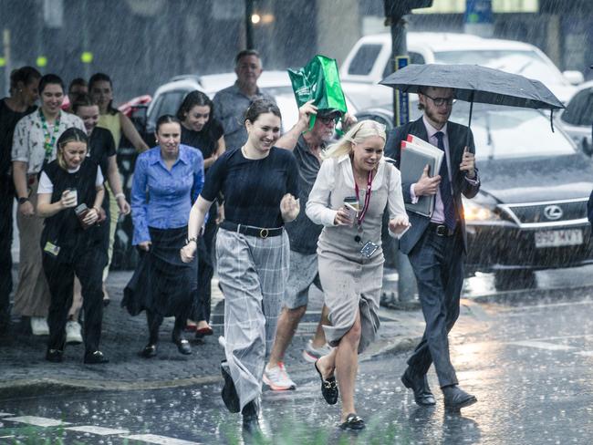 CBD workers caught short in the Brisbane CBD. Picture: NewsWire / Glenn Campbell