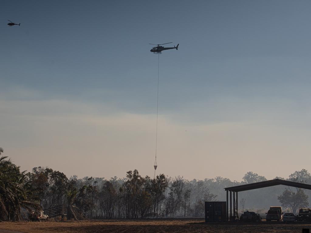 About eight properties were under threat in the Livingstone area on July 30 as a bushfire ripped through the area. Three aircraft, four helicopters and 20 volunteer crews and Bushfires NT fireys battled together to contain the blaze on Perentie Rd. One firefighter was injured and admitted to hospital with burns. Picture: Che Chorley