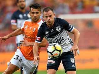 Melbourne Victory's Leigh Broxham (right) gets past his Roar opponent. The Victory will have another derby to look forward to in 2019 with Western Melbourne set the join the A-League. Picture: DAN PELED