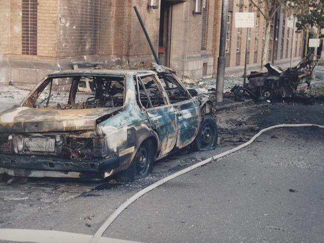The explosions caused a massive amount of damage. This is what’s left of then detective Charlie Bezzina’s car, parked behind the blast car. Picture: HWT library.