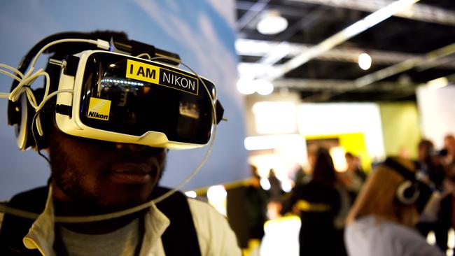 A man views photos from Nikon’s first 360-degree camera. Photo: AFP PHOTO / PATRIK STOLLARZ.