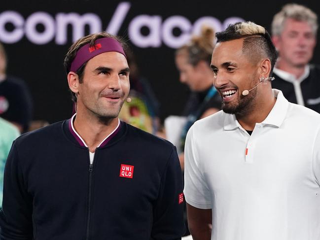 Roger Federer of Switzerland and Nick Kyrgios of Australia pose for a photo during the Rally For Relief at Rod Laver Arena in Melbourne, Wednesday, January 15, 2020. Tennis stars have come together for the Rally for Relief at Rod Laver Arena in Melbourne to raise money in aid of the bushfire relief efforts across Australia. (AAP Image/Scott Barbour) NO ARCHIVING