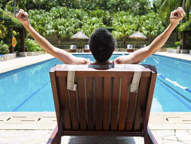 man sitting on a pool chair for relax.