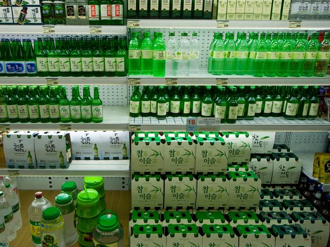 Shop shelves filled with a variety of Soju bottles, which is the national drink.