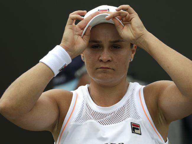 Australia's Ashleigh Barty adjusts her cap during a break in a women's singles match against United States' Alison Riske during day seven of the Wimbledon Tennis Championships in London, Monday, July 8, 2019. (AP Photo/Ben Curtis)