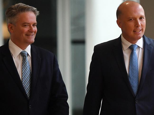 Senator Matthias Cormann  and former Minister for Home Affairs Peter Dutton arrive for the Liberal Party room meeting at Parliament House in Canberra, Friday, August 24, 2018. Malcolm Turnbull has declared the Liberal Party leadership vacant, following a second leadership challenge, this week. (AAP Image/Sam Mooy) NO ARCHIVING