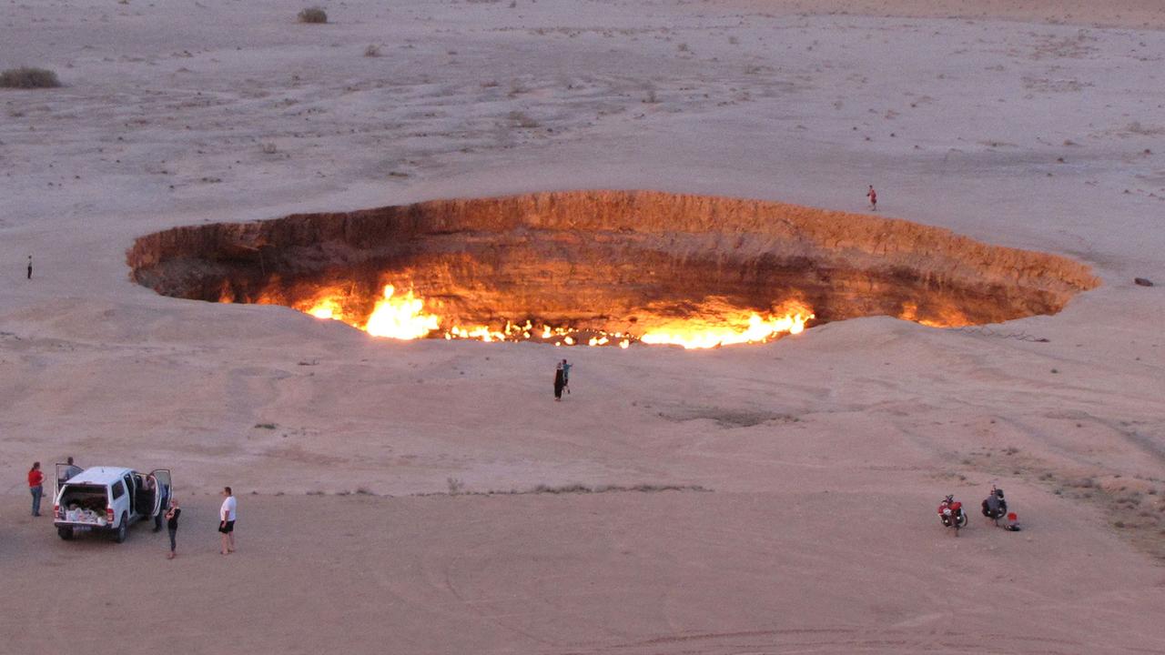 People visiting ‘The Gateway to Hell’ on June 11, 2014 in the heart of Turkmenistan's Karakum desert. Picture: Igor Sasin/AFP