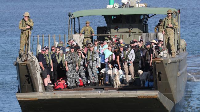 Mallacoota evacuees from the HMAS Choules are brought to shore on landing crafts at Hastings after the devastating blazes. Picture: David Crosling/AAP