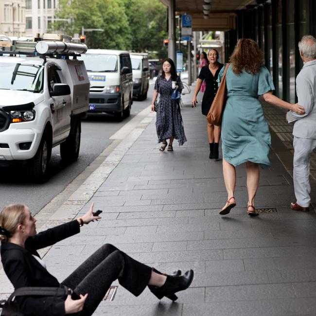 Newscorp journalist Eliza Barr on the ground after being assaulted by Remo Cignetti.