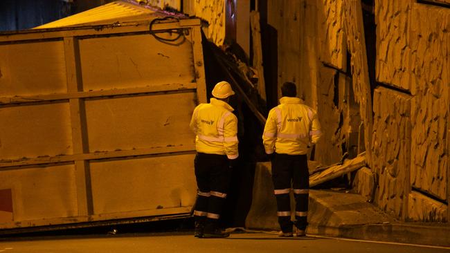 Crews inspect the damage following the crash. Picture: Damian Hofman