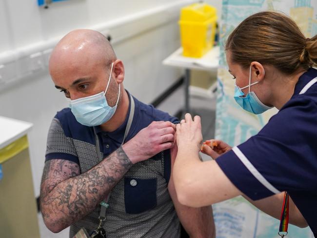 SUNDERLAND, ENGLAND - JANUARY 26: Dale Snowden from Sunderland receives the AstraZeneca/Oxford University Covid-19 vaccine at the NHS Nightingale North East hospital on January 26, 2021 in Sunderland, England. The 460-bed hospital was created in the spring, as England's health system grappled with the first wave of covid-19 infections. It was placed on standby but never admitted patients. Based at the Washington International Advanced Manufacturing Park (IAMP) development the building was to be used as part of the region's advanced manufacturing sector until it was repurposed for use as a temporary hospital. (Photo by Ian Forsyth/Getty Images)