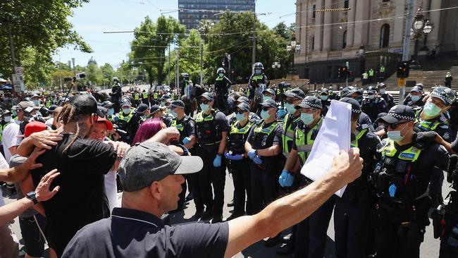 Protesters confront a heavy police presence after midday at Parliament House. Picture: NCA NewsWire / Ian Currie