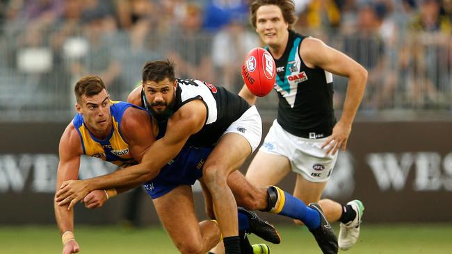 Scott Lycett of the Eagles gets his handball away under heavy pressure from Paddy Ryder. Picture: Paul Kane/Getty Images