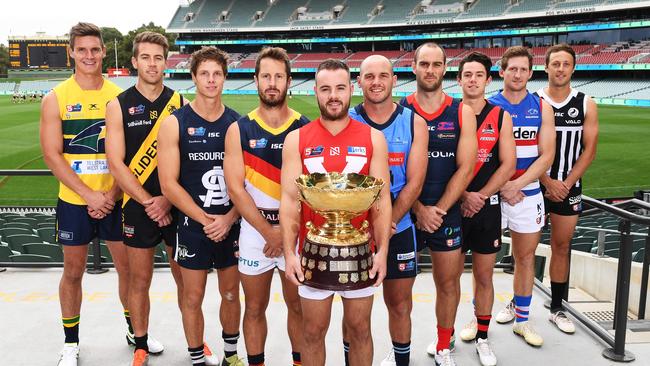 Luke Thompson (Eagles), Chris Curran (Glenelg), Matt Rose (South Adelaide), Matthew Wright (Adelaide), Max Thring (North Adelaide) ,Zane Kirkwood (Sturt), Jace Bode (Norwood), Hugh Haysman (West Adelaide), Trent Goodrem (Central District) and Cam Sutcliffe (Port Adelaide) with the cup up for grabs. Picture: AAP/Mark Brake