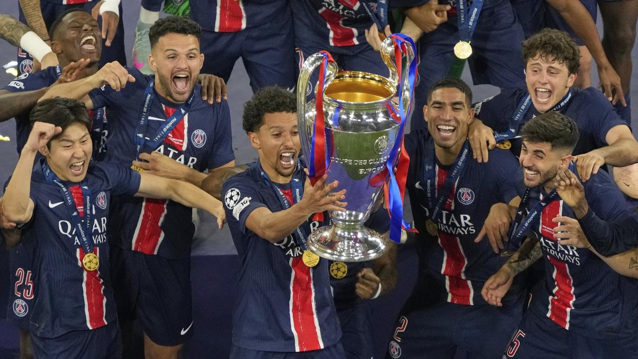 PSG's Marquinhos celebrates with the trophy. AP Photo/Michael Probst)