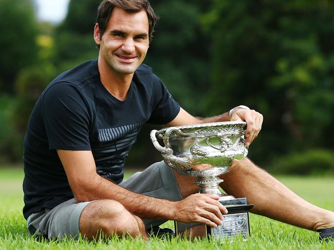 Roger Federer poses with the Norman Brookes Challenge Cup after winning the 2018 Australian Open Men's Final.