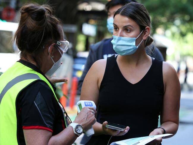 SYDNEY, AUSTRALIA - SEPTEMBER 24: A healthcare worker assists a person as they arrive to check in at the Sonic Healthcare COVID-19 Vaccination hub in the CBD on September 24, 2021 in Sydney, Australia. COVID-19 restrictions have eased for people in NSW who are fully vaccinated, with up to five people allowed to gather outdoors. The eased restrictions only apply to people who don't live in the 12 local government areas of concern and have received two doses of a COVID-19 vaccine. NSW Premier Gladys Berejiklian has outlined a roadmap out of the current statewide lockdown, with a range of restrictions to be eased when 70% of the state's eligible population are fully vaccinated. These freedoms will only be restored for the fully vaccinated. (Photo by Lisa Maree Williams/Getty Images)