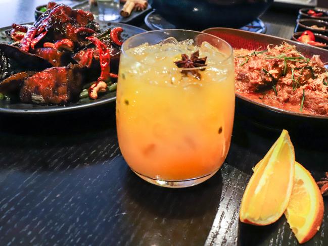 The Malaya’s szechuan eggplant, Queue Tea cocktail and coconut beef rendang. Picture: Jenifer Jagielski