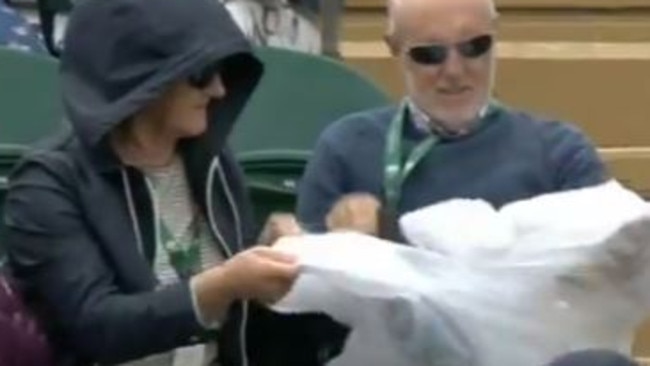 Eventually the man, totally beaten by the inanimate object, gives up and removes the poncho altogether. Image: BBC