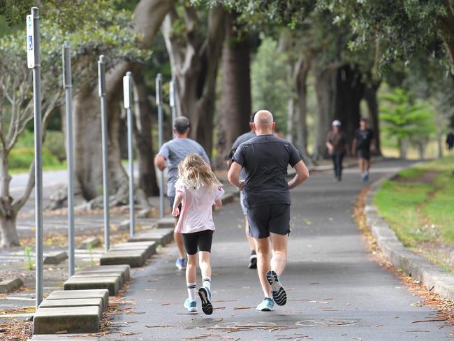 Joggers enjoy Centennial Park in Sydney on a cloudy morning. Picture: Simon Bullard.