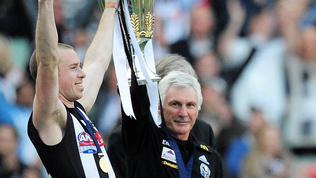 Collingwood captain Nick Maxwell with coach Mick Malthouse and the AFL premiership.