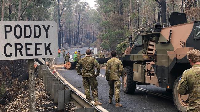 A lack of access to many of the affected areas is meaning much of the work is being done by hand. Picture: Department of Defence