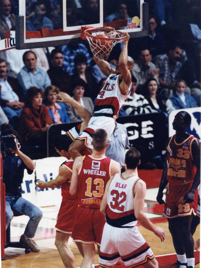 Hobart’s Calvin Talford hangs of the basket during a Adelaide 36ers vs Hobart Devils NBL match in 1994.