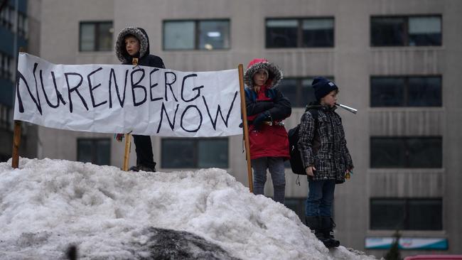 Children stand before a banner during a protest by truck drivers over pandemic health rules and the Trudeau government. Picture: AFP