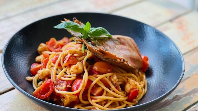 Spaghetti with a whisky flambé prawn bisque, reef bug, cherry tomatoes, basil and lime zest at Il Chiosco at Trinity Beach. Picture: Supplied