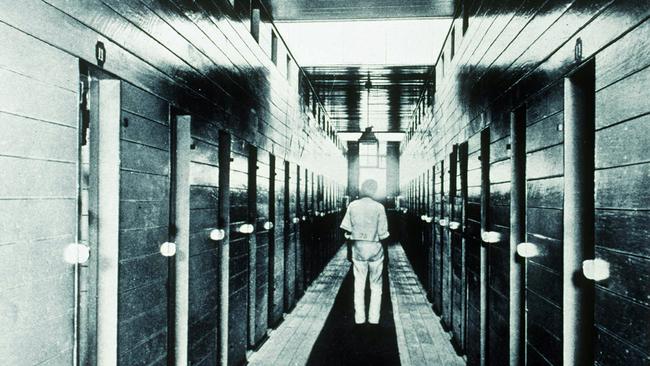 A prisoner stands by prison cell doors on St Helena Island. Picture: Courtesy of the John Oxley Library