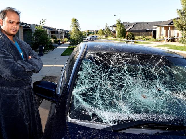 Imtiaz Rahman next to his car damaged by the people from the party house. Picture: Nicole Garmston