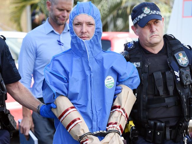 Police take a man into custody following an alleged murder at a unit at 146 Cambridge St, Granville.