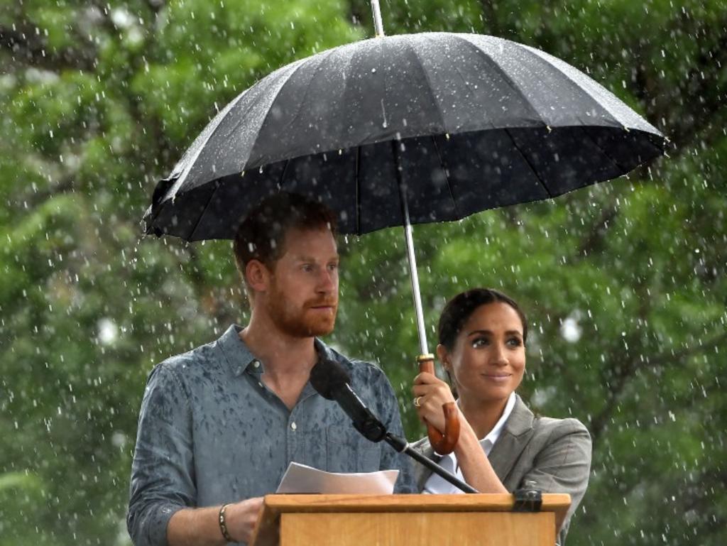 The pair braved the rain in Dubbo, where locals waved cardboard cut-outs of the couple and produced a specially brewed beer dubbed “Dubbo Royale”. Picture: AAP