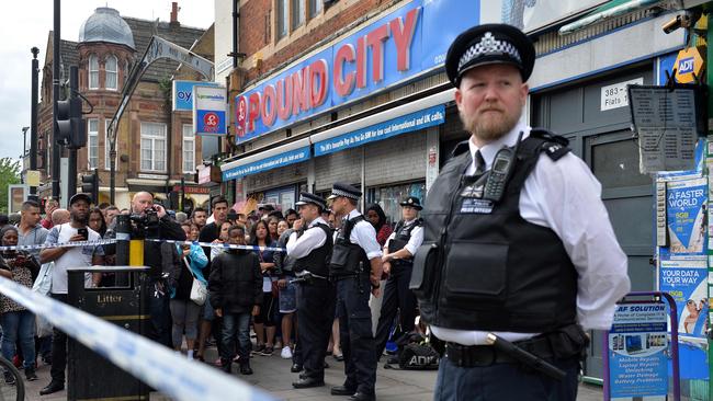 A policeman stands on duty outside a shop, with a residential flat above, in East Ham in East London after a raid as police continue their investigations into the June 3 London Bridge terror attacks. Picture: Justin Tallis