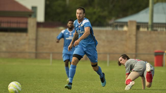 South West Queensland Thunder striker Brodie Welch,leaves Holland Park Hawks defender Joshua Elmer in his wake.