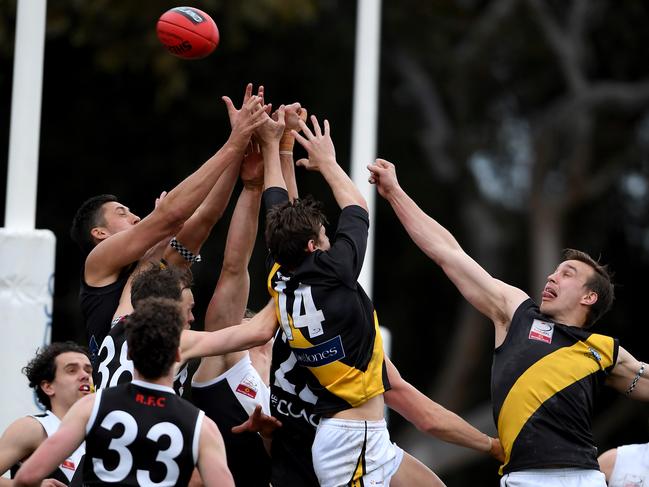 Players contest the ball on the goal line. Picture: Andy Brownbill