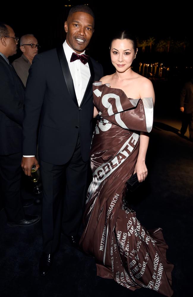 Jamie Foxx with China Chow, who wore a gown inspired by a chocolate wrapper.