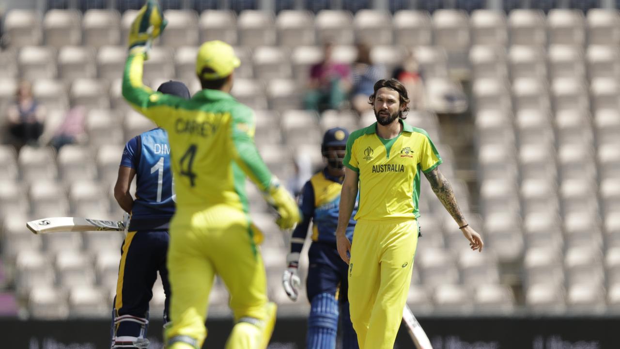 Australia’s Kane Richardson, right, celebrates taking the wicket of Sri Lanka's captain Dimuth Karunaratne in a World Cup warm-up match. Picture: AP Photo/Matt Dunham