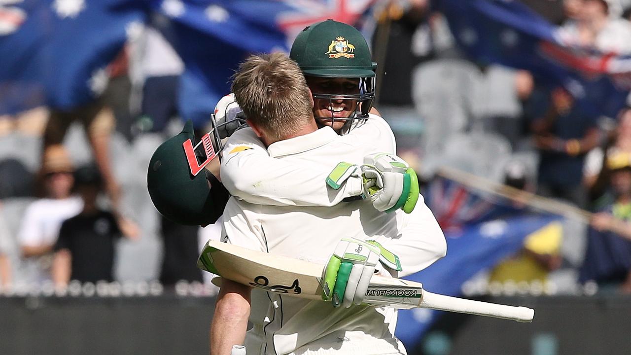 Warner and Khawaja embrace after the former’s century against Pakistan in 2016. Picture: Wayne Ludbey