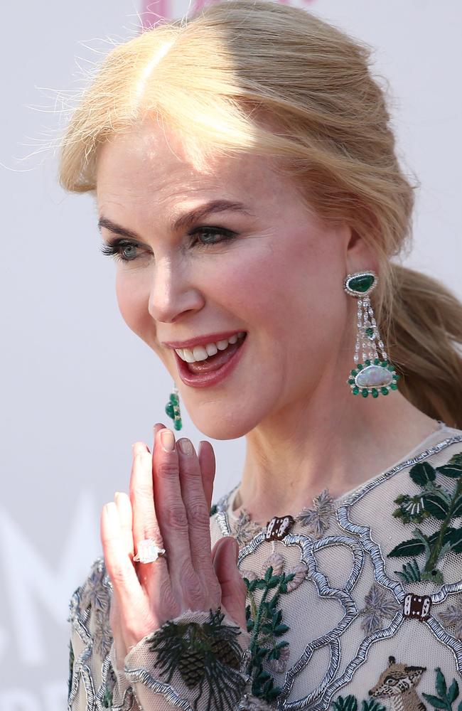 Kidman teamed the McQueen gown with a pair of emerald and diamond drop earrings ... and her huge engagement bling. Picture: AFP