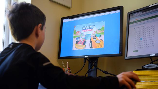 A young boy navigates online learning resources provided by a school in England this week. Picture: AFP.