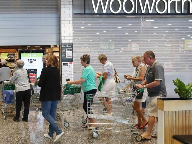 Early morning older shoppers arrive at Ascot Woolworths. Woolworths say they closed early on Wednesday night to restock shelves. Photographer: Liam Kidston